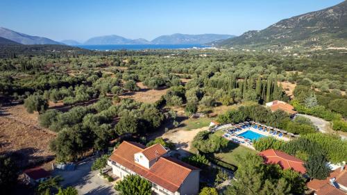 an aerial view of a house with a swimming pool and trees at Stalaktites Studios in Sami