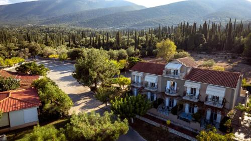 an aerial view of a house with mountains in the background at Stalaktites Studios in Sami