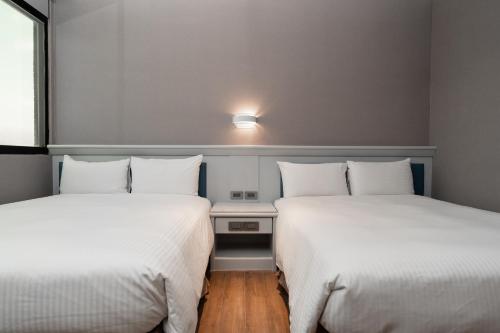 Postel nebo postele na pokoji v ubytování Fu Hsiang Hotel