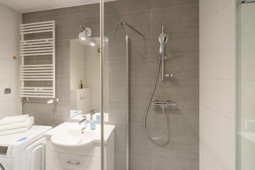 un bagno con doccia, WC e lavandino di APT Nadmorskie - Solne a Kołobrzeg