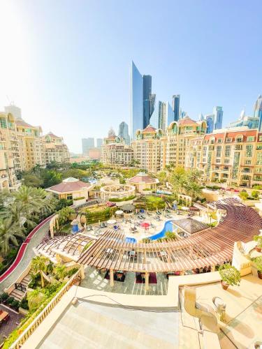 an aerial view of a resort with a pool and buildings at Swissôtel Al Murooj Dubai in Dubai
