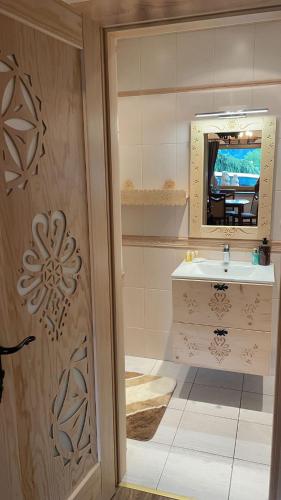 a bathroom with a sink and a mirror at Świstakówka in Szczyrk