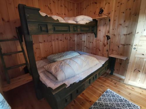 a bed in a room with wooden walls at Sundebu, Spacious 5-Bedroom mountain cabin near Ski and Hiking in Rauland