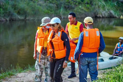 a group of people wearing life vests standing next to a river at Andasibe Lemurs Lodge in Andasibe