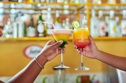 two people holding cocktails in their hands at Andasibe Lemurs Lodge in Andasibe