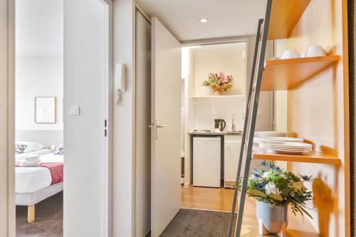a small apartment with a bedroom and a bed at Appart'City Classic Nantes Viarme in Nantes