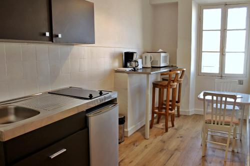 a kitchen with a sink and a stove top oven at Viva Riviera - 10 Rue Commandant André in Cannes