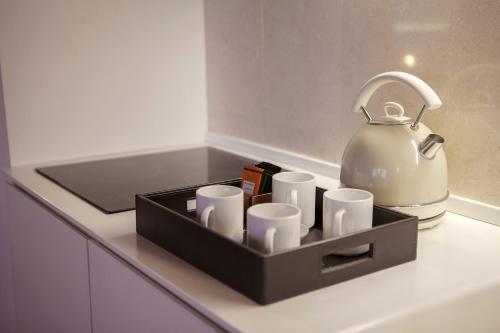 a tray with cups and a tea kettle on a counter at Ca' della Scimmia - Rialto Bridge, Venice in Venice