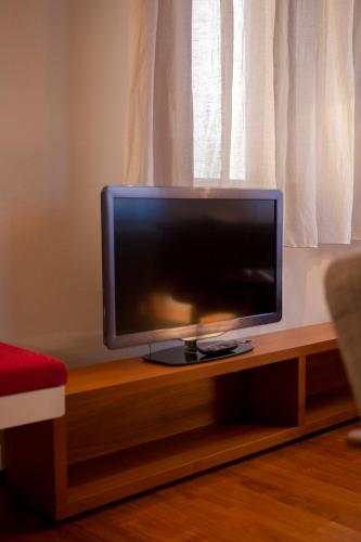 a flat screen tv sitting on top of a table at Ca' della Scimmia - Rialto Bridge, Venice in Venice