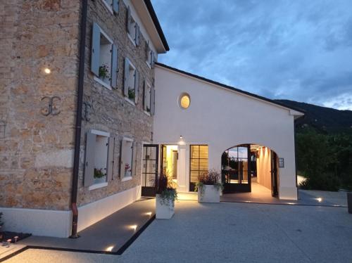 a brick building with a courtyard in front of it at Locanda MaMaGiò in Valdobbiadene