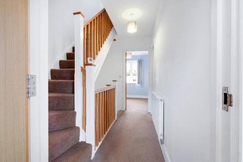 a hallway with stairs in a house at London Heathrow Living Holywell Serviced Houses - 3 and 4 bedrooms By Ferndale in Stanwell