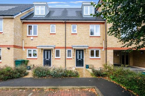an image of a brick house with a driveway at London Heathrow Living Holywell Serviced Houses - 3 and 4 bedrooms By Ferndale in Stanwell