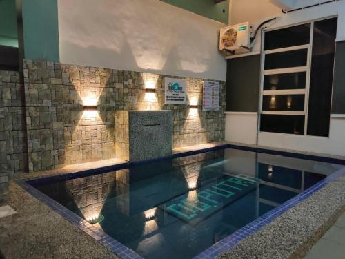 a swimming pool with lights in a house at D'Q Putra Homestay Melaka Unit MIQA in Melaka