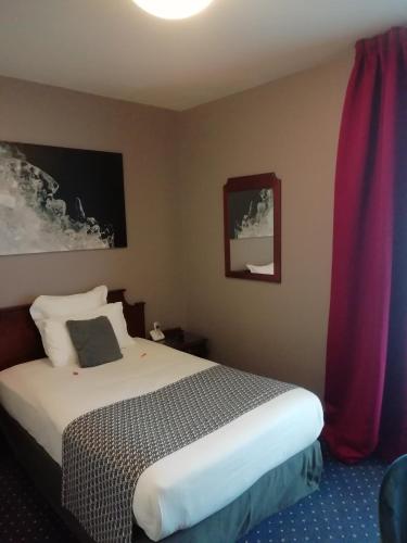 a bedroom with a bed and a red curtain at Amiral Hôtel in Paris