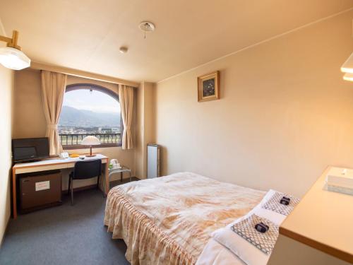 Postel nebo postele na pokoji v ubytování Tabist Hotel Sun Plaza Fuefuki Isawa