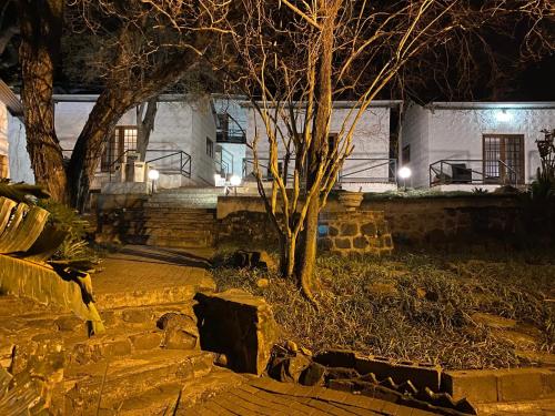 a house with a tree in front of it at night at Farquhar Lodge in Ladysmith