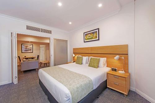 A bed or beds in a room at Quality Apartments Adelaide Central