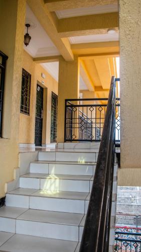 a set of stairs in a building with a railing at Residence Le Bonheur - Serviced apartment by Douala Airport/Mall in Douala