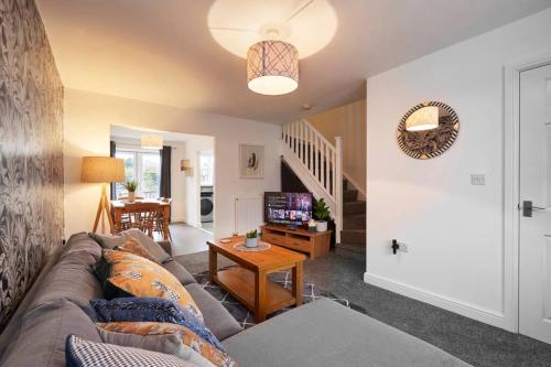 a living room with a couch and a tv at Halifax Gorgeous New Home - 3 bedrooms in Halifax