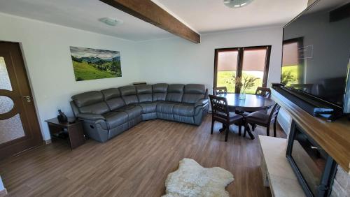 a living room with a couch and a table at Vila Pestera in Peştera