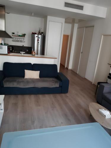 un salon avec un canapé bleu et une table dans l'établissement Magnifique logement entier T2 vieux port, à Marseille