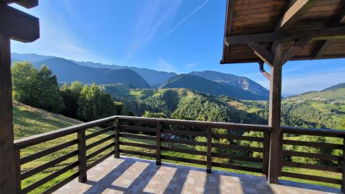 a view from a cabin balcony with mountains in the background at Vila Pestera in Peştera