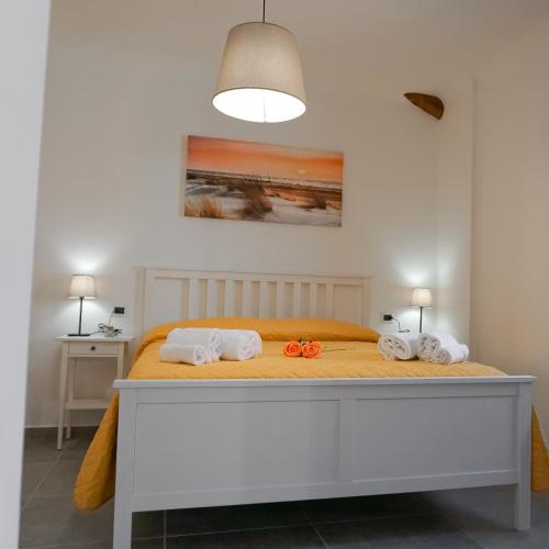 a bedroom with a bed with two orange bows on it at La Terrazza Azzurra in Bellisio di Sopra