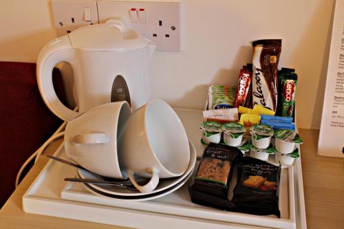 a refrigerator filled with food and a coffee pot at The Golden Larches in Lochearnhead