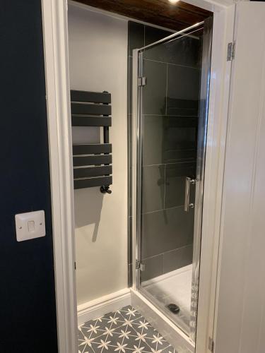 a shower with a glass door in a bathroom at Min-Y-Fford sleeps 6 plus pet in Newport