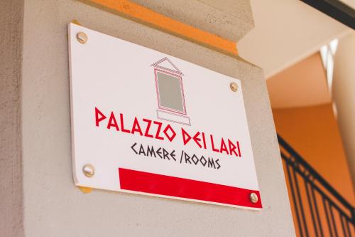 a sign on the side of a building with a window at Palazzo dei Lari in Scafati