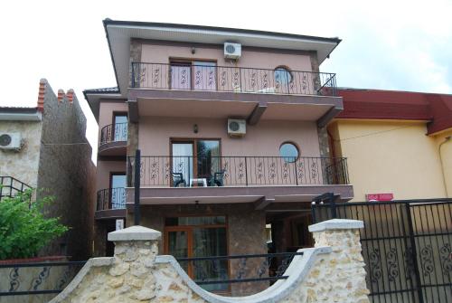 a large house with a balcony and a staircase at Vila Silvia in Eforie Sud