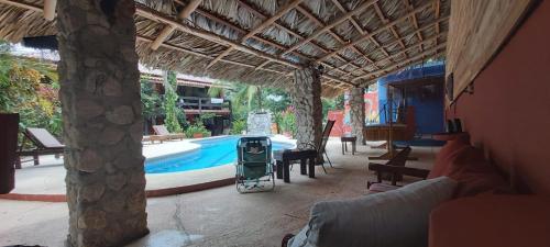 a house with a swimming pool and a patio at Massai Apartments in Playa Flamingo