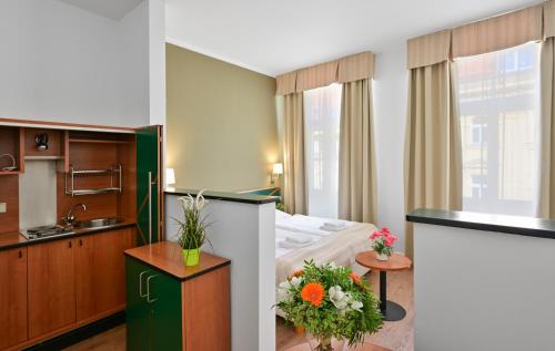 a hotel room with a bed and a kitchen at Hotel Malá Strana in Prague