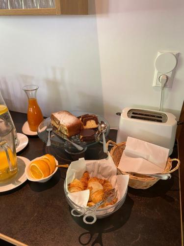 a table with baskets of bread and oranges on it at Appartement Schörghofer in Filzmoos