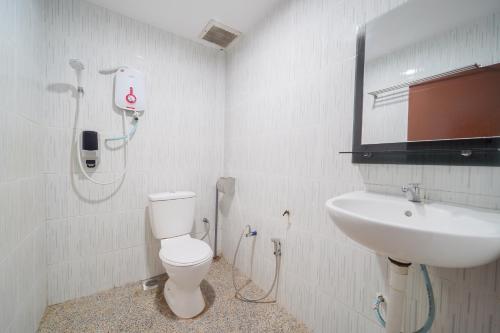 a bathroom with a toilet and a sink at JMA FERRINGHI BEACH HOTEL in Batu Ferringhi