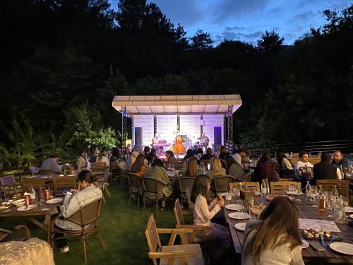 a group of people sitting at tables at an event at DiliJazz Hotel & Restaurant in Dilijan