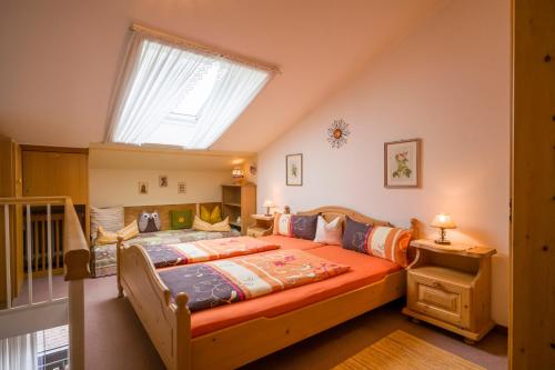 ein Schlafzimmer mit einem großen Bett und einem großen Fenster in der Unterkunft Ferienwohnung Stigloher im Bergschlößl in Oberaudorf