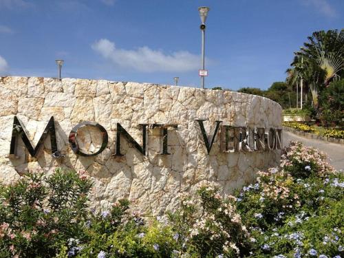 a stone wall with the sign for monongahela at Ocean Front studio , step to the beach in Cul de Sac