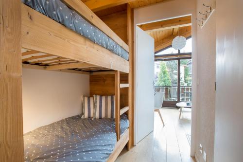 a bedroom with bunk beds in a house at Stunning renovated studio with mezzanine in Morzine