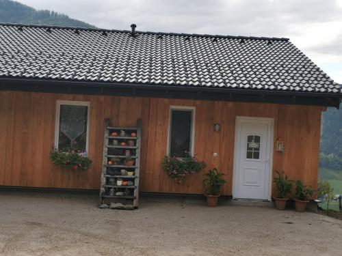 a small building with a door and a shelf of wine bottles at Gemütliches Häuschen "Bergblick Hollnhof" lädt zum verweilen ein in Donnersbach