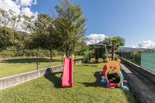 a park with a playground with a slide at Casa Vacanza Elena in San Bernardino Verbano