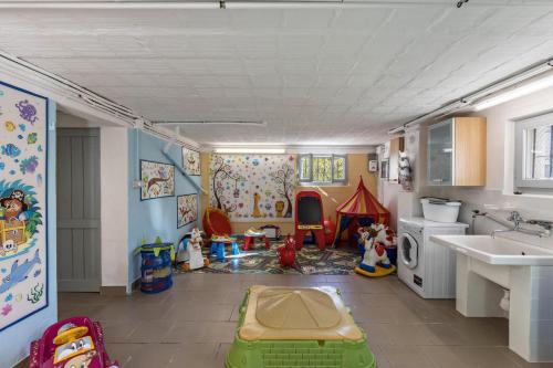 a kitchen with a play room with toys in it at Casa Vacanza Elena in San Bernardino Verbano