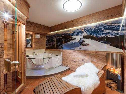 a jacuzzi tub in a room with wooden walls at Chalet Weinberg Top 1 & Top 2 by Apartment Managers in Kirchberg in Tirol