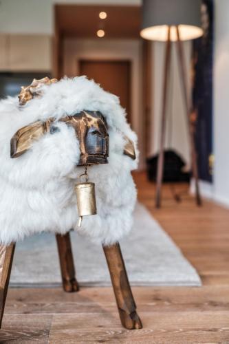 a stuffed animal with a bell on its legs in a room at Luxury Panorama apartment with AlpenGold Spa Access in Davos