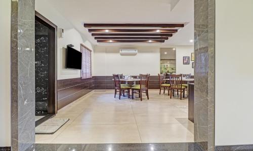 a dining room with a table and chairs at Treebo Premium Raj Vista Global Village in Bengaluru
