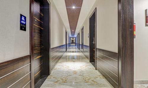 a hallway of a building with a long corridor at Treebo Premium Raj Vista Global Village in Bengaluru