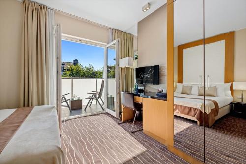 a hotel room with a bed and a desk at Molo Residence in Sopot