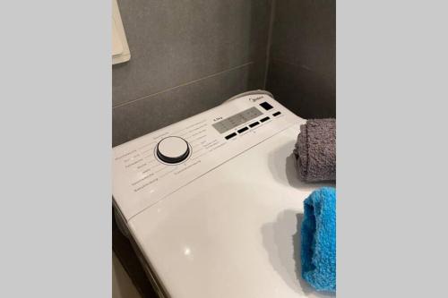 a washing machine in a bathroom with a blue towel at Die kleine Post in Schleiden