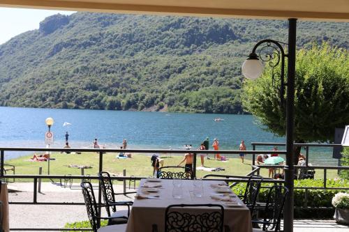a table and chairs with a view of a body of water at Hotel Ristorante La Quartina in Mergozzo