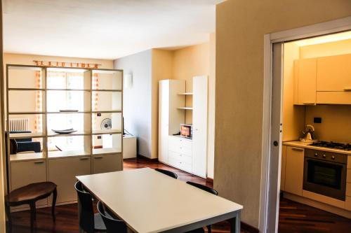 a kitchen with a white table and a white table at Hotel Ristorante La Quartina in Mergozzo